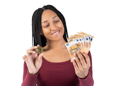 Black woman with some fifty euro bills shows a bitcoin on a white background