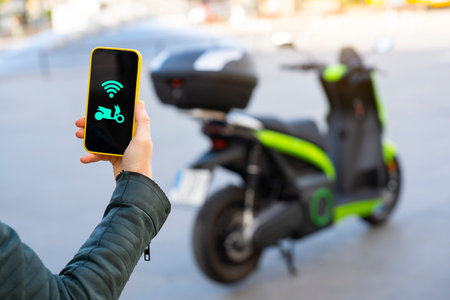 Connecting an electric motorcycle with the smartphoneの写真素材