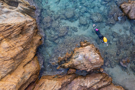 Aerial top view from drone of a swimmer in open water with wetsuit and buoyの写真素材