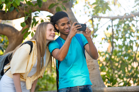 Young multiracial couple is taking a picture with a smartphone