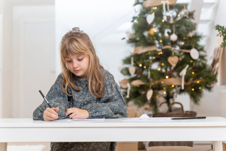Little girl writing a letter to Santa Claus or the three wise menの写真素材