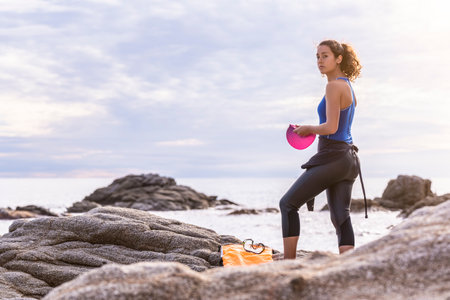 Young swimming woman about to enter the seaの写真素材