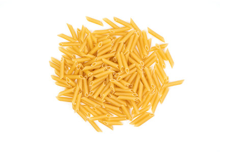 Pile of dried macaroni on top of a white background in studioの写真素材