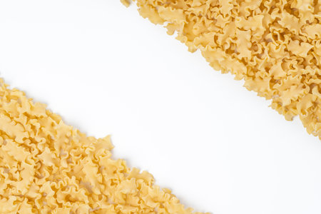 Background image with dry mini lasagna noodles with copy space on the centerの写真素材
