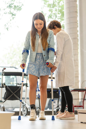 Young woman trying out crutches in a storeの写真素材