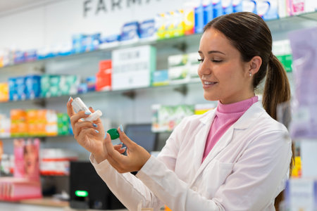 A female pharmacist showing an inhalerの写真素材