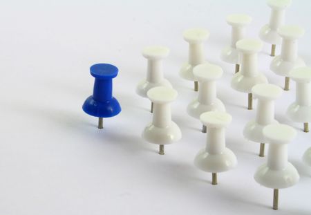 Leadership, a blue pin in front of several white pinsの写真素材