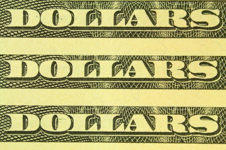 macro of word dollars from dollar bills