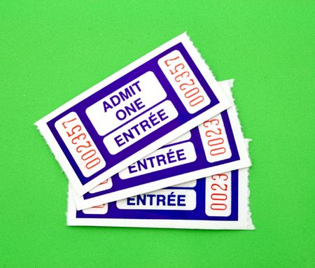 thre admit one tickets over a green surfaceの写真素材