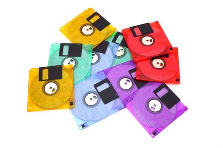 several floppy disks of different colors scattered over a white surfaceの写真素材