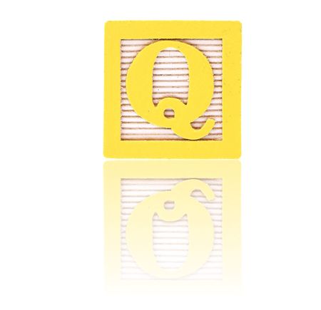 letter q in an alphabet wood block on a reflective surfaceの写真素材