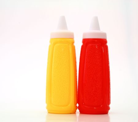 yellow and red bottle on a white surfaceの写真素材