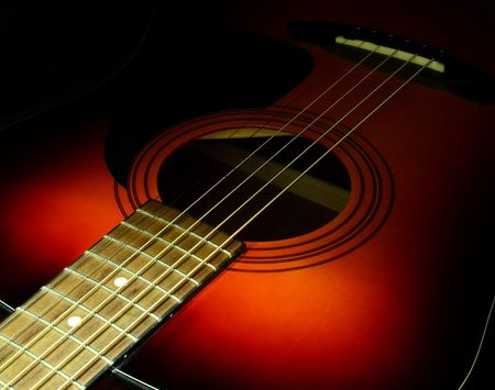 detail view of the sound hole and strings of an acoustic guitarの写真素材