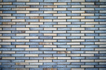 Vintage brick wall; multi-colored bricks, textured background; urban surfaceの写真素材