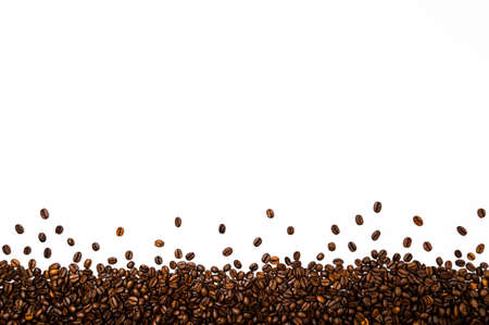 Roasted coffee or espresso beans border or frame against white background. Table top view, flat lay, copy space.の写真素材