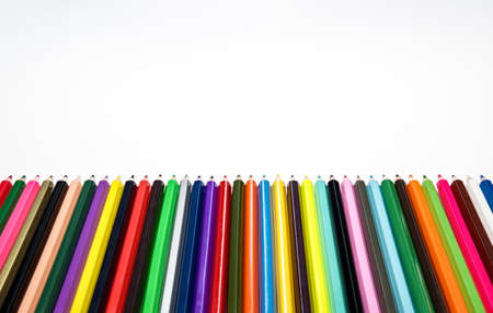 Creative back to school concept. Colored crayons against white background. Table top view, flat lay, copy space.の写真素材