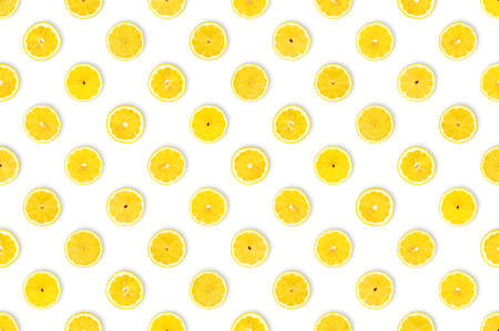 Sour makes fun: healthy diet concept. Pattern with important nutrients. Freshly cut lemon slices against white background. Vitamin C background, table top view, flat lay.の写真素材