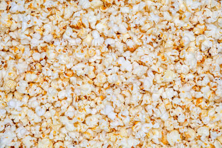 Crunchy popcorn background. Whether sweet or salty - enough freshly popped popcorn for the next three movie nights.の写真素材