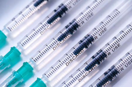 Coronavirus vaccination against SARS-CoV-2. Close up of disposable medical syringes with COVID-19 vaccine.の写真素材