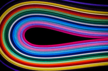 Close up of curved sheets of colored paper. Colorful craft and office supplies concept.の写真素材