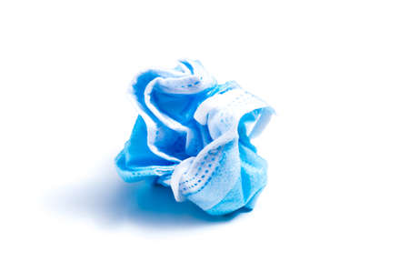 Crumpled and discarded face mask on a white background.の写真素材