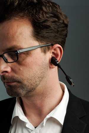 A man, about 40 years, with a USB cable in his earのeditorial素材