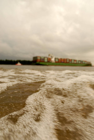 A close up from the ground in the port of Hamburg with a crane in the backgroundの写真素材