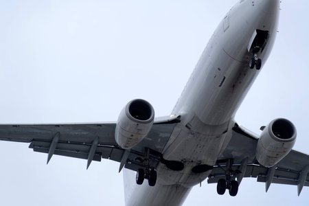 The underside of a modern airplane and its landing gearの写真素材
