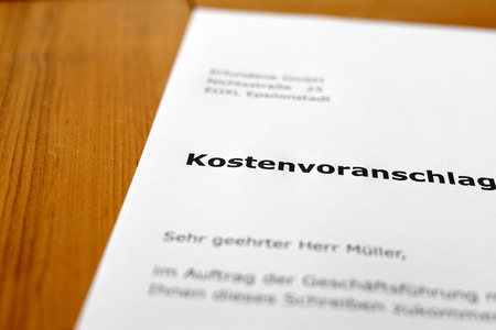 A letter on a wooden table - estimate of costの写真素材