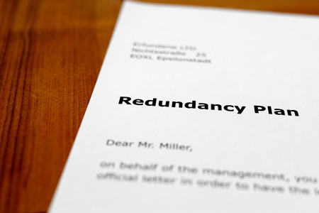 A letter on a wooden table - redundancy planの写真素材