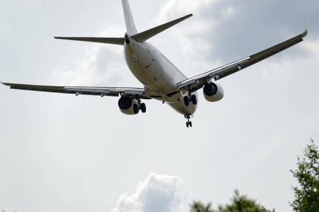 The underside of a modern airplane and its landing gearの写真素材
