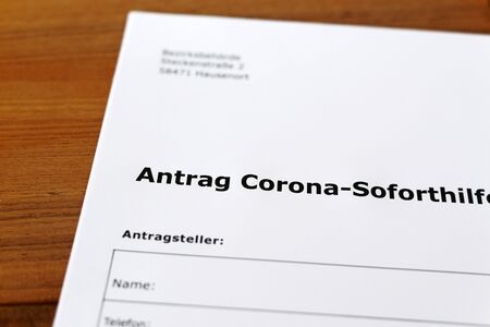 A sheet of paper with the german words "Antrag Corona-Soforthilfe" - Translation in englisch: Application for Corona immediate help.の写真素材