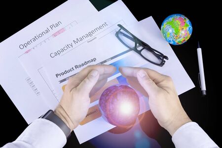 A businessman tries to forecast the economy by a magic glass ballの写真素材