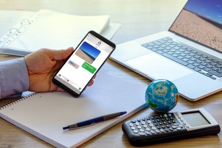 Online alignment for the next vacation trip during the corona crisis by mobile phoneの写真素材