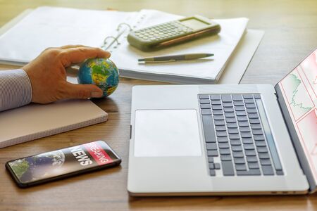A businessman plays with a stress ball during a crash at the stock marketの写真素材