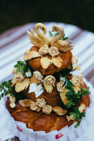 Wedding cake decorated with flowers in the form of a swanの写真素材