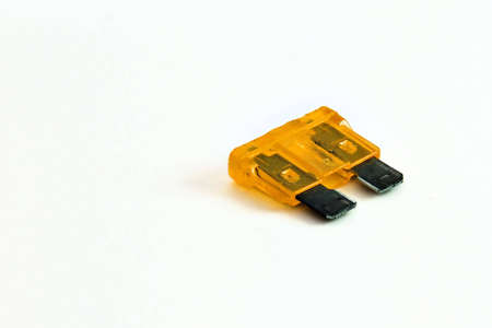 Car fuse in orange color and isolated on a white background.の写真素材