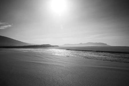 Wonderful sunset on Galicia beach with a river crossing throughの写真素材
