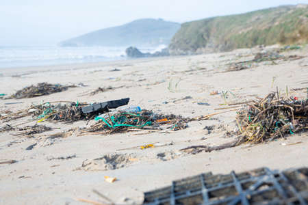 A lot of human trash given back from the ocean ends on the beach contaminating it and all the surroundingの写真素材