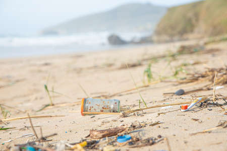 A lot of human trash given back from the ocean ends on the beach contaminating it and all the surroundingの写真素材