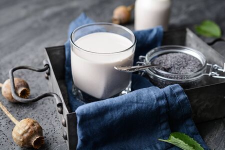 Healthy poppy seed milk, dairy free and calcium rich vegan drink in a glassの写真素材