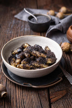 Classic Slovakian food called Sulance, sweet potato dumplings with poppy seeds in a bowlの写真素材