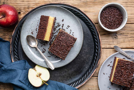 Delicious chocolate dessert with creamy apple filling, topped with crispy sprinklesの写真素材