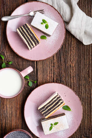Sweet dessert, layered poppy seed cake dusted with powdered sugar