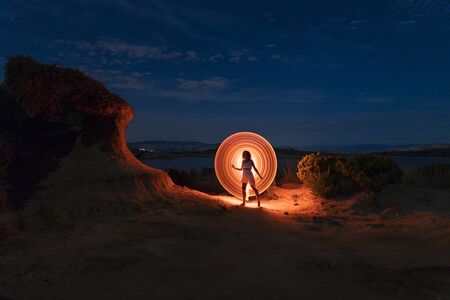 lightpainting in the night on a lonely beach in Croatia nearby sandstone