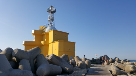 Tourists walk along the breakwater.