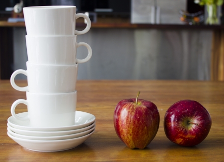 White cups and red applesの写真素材