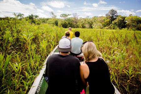 Boat navigating in the dense jungle at amazon riverのeditorial素材