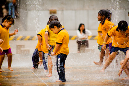 Happy kids playing in the water fountainのeditorial素材