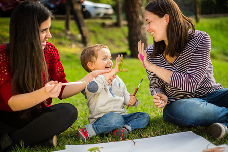 Happy Mother and son child painting in the park.の写真素材